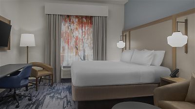 Hotel room with large king bed and TV