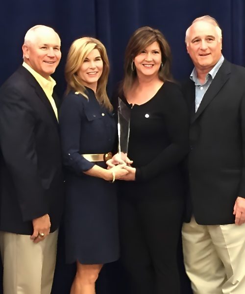 Daly Seven team holding an award together